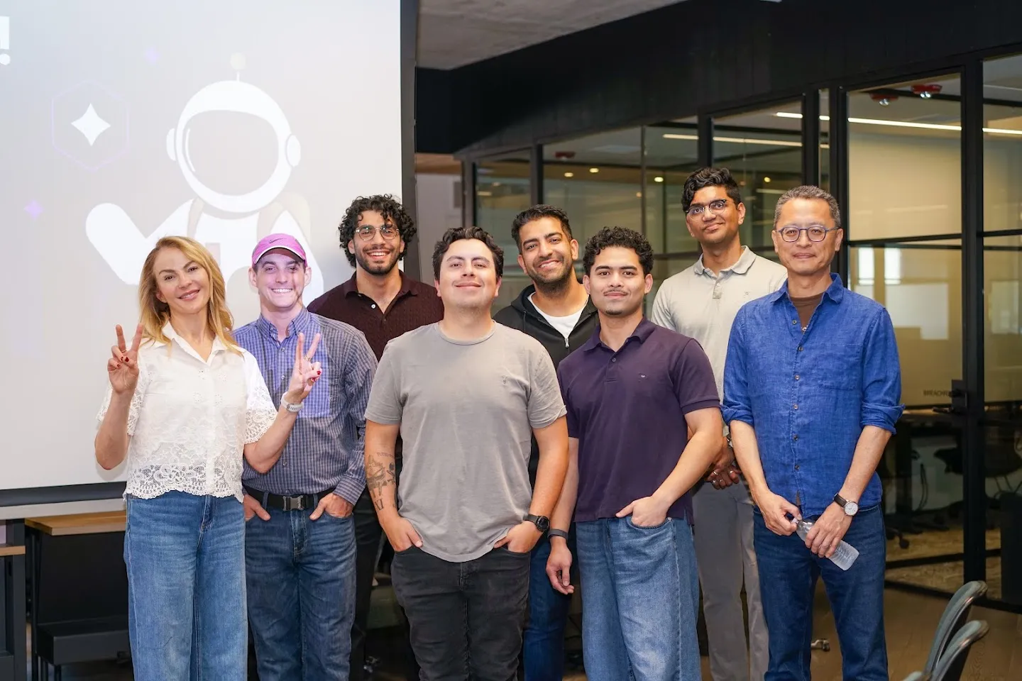 Speakers posing in front of the Agents and APIs Developer Meetup slide