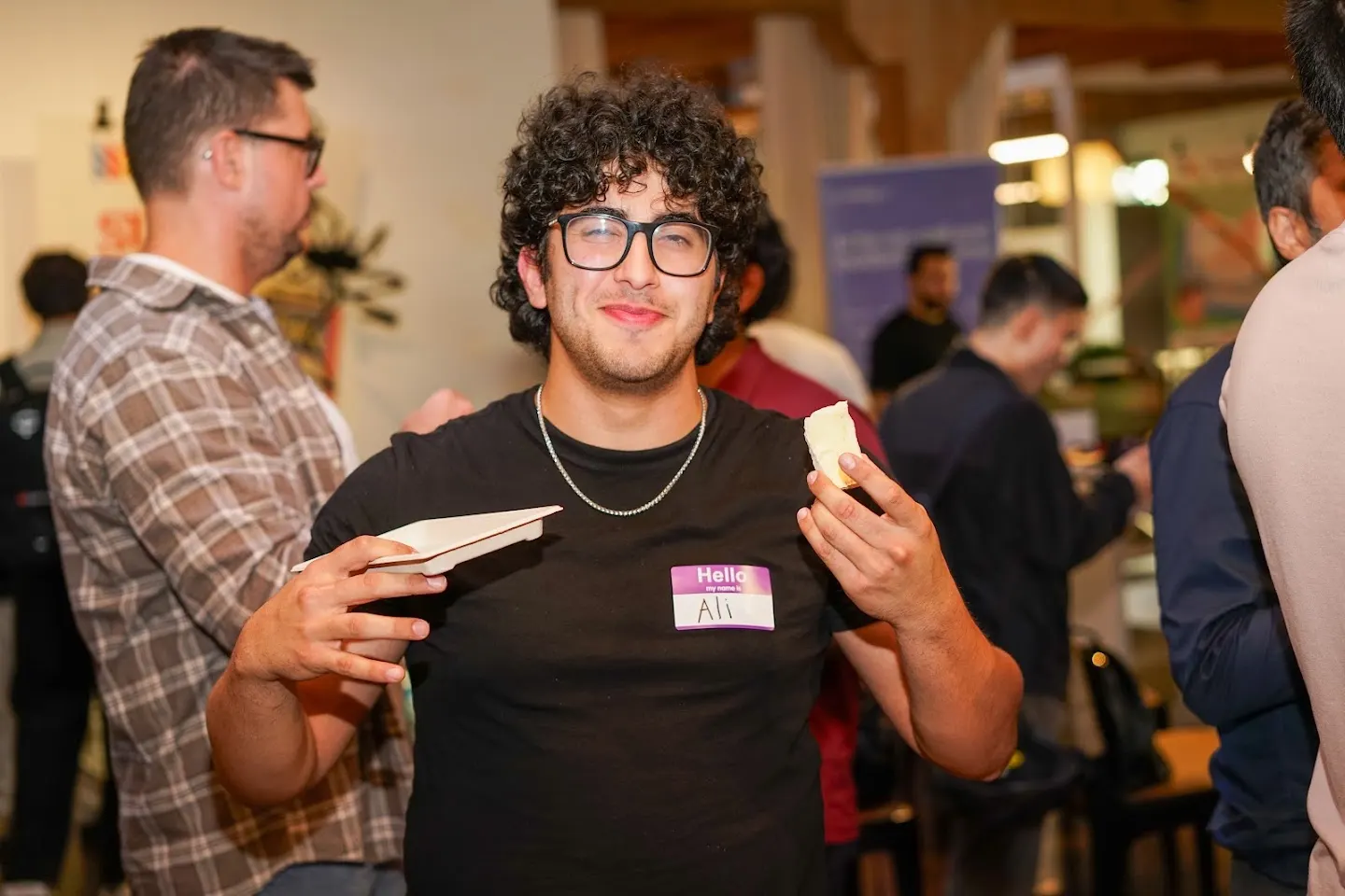 Attendees chatting and connecting at SF Tech Week 2026 w/ PostHog, Convex, & Elastic (photo 4)