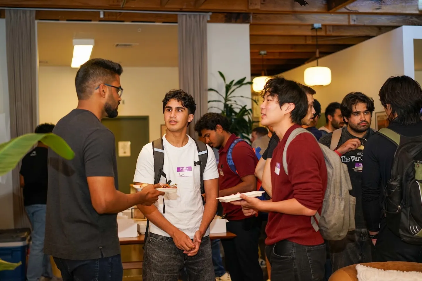 Developers talking over food and drinks at AI Agents Builder Night