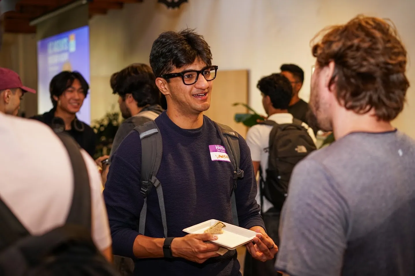 Developers talking over food and drinks at AI Agents Builder Night