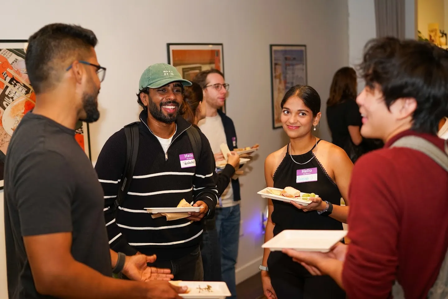 Developers talking over food and drinks at AI Agents Builder Night