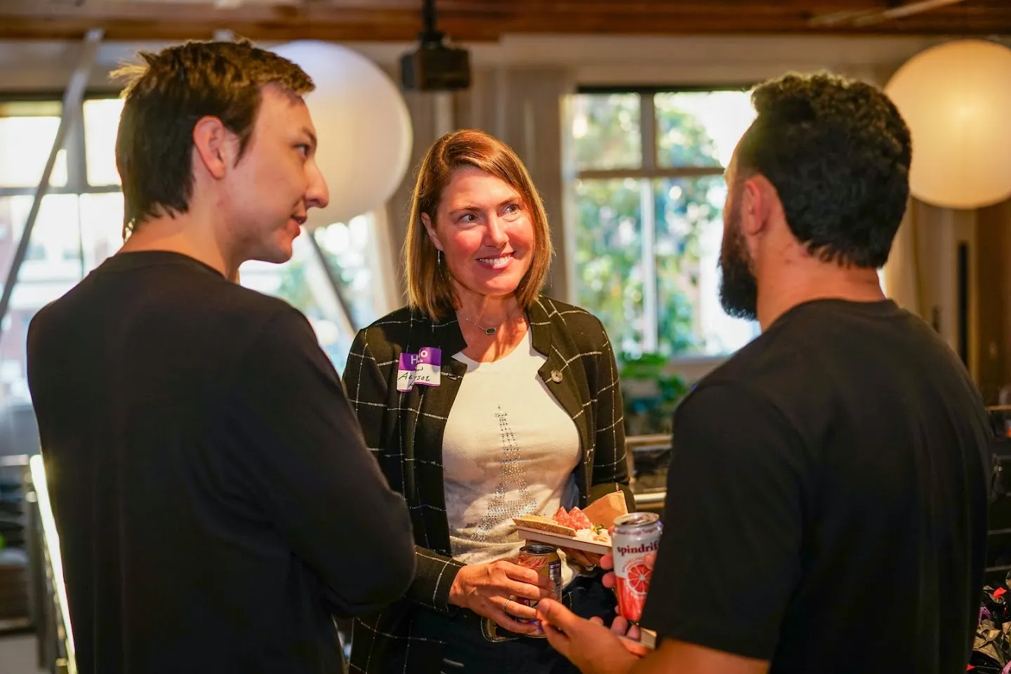 Developers talking over food and drinks at AI Agents Builder Night