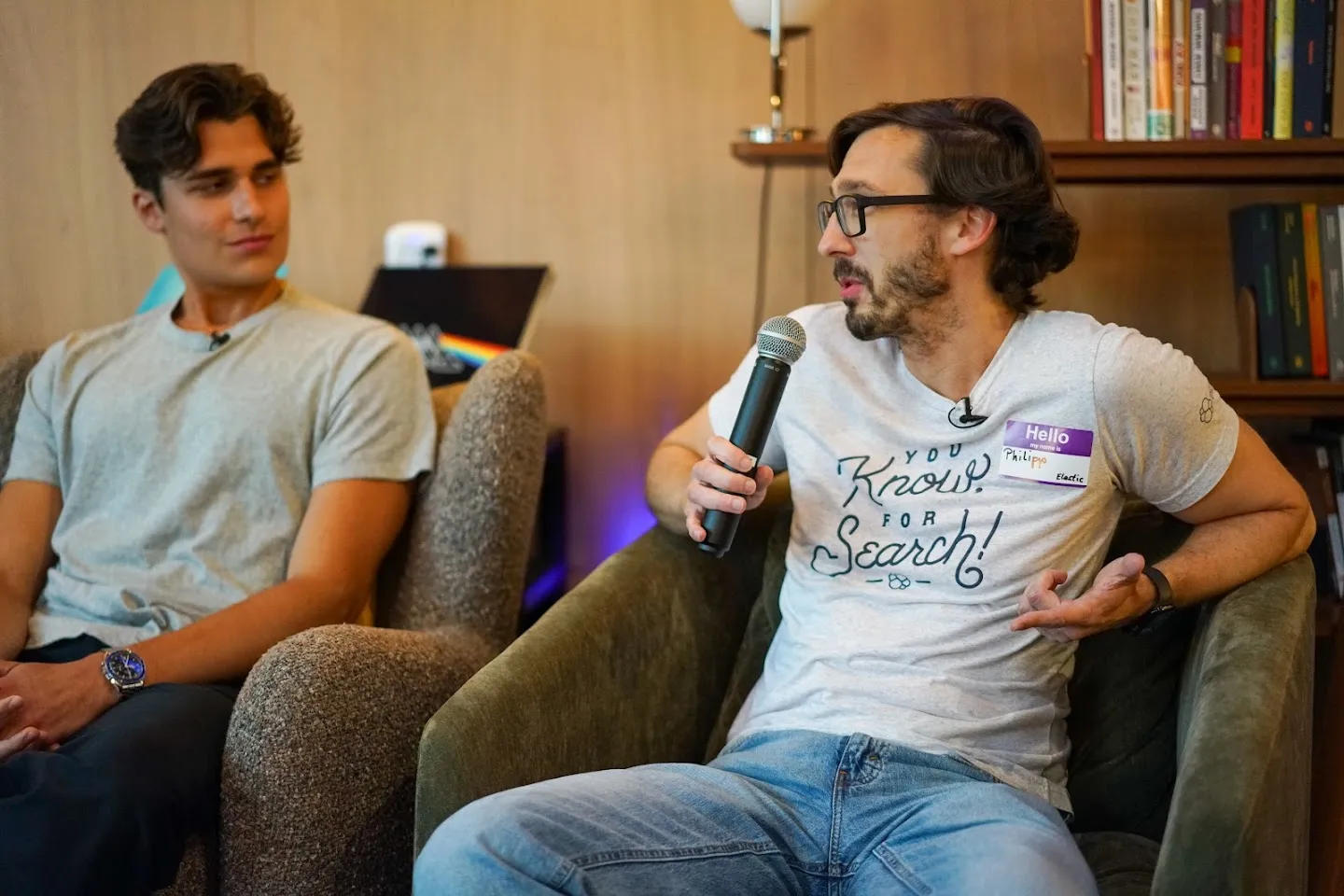 Panelists seated on sofas with microphones at AI Agents Builder Night