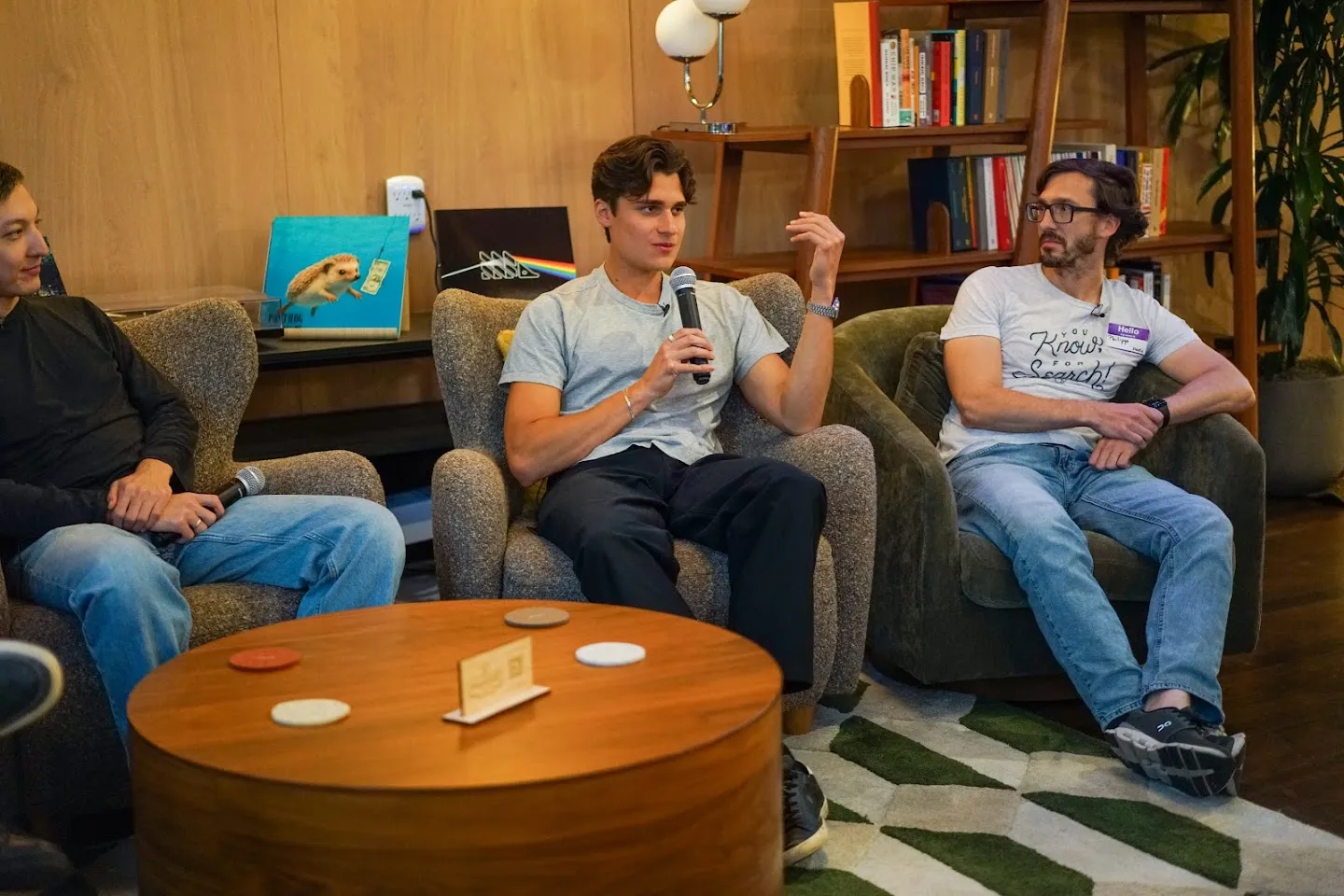 Panelists seated on sofas with microphones at AI Agents Builder Night