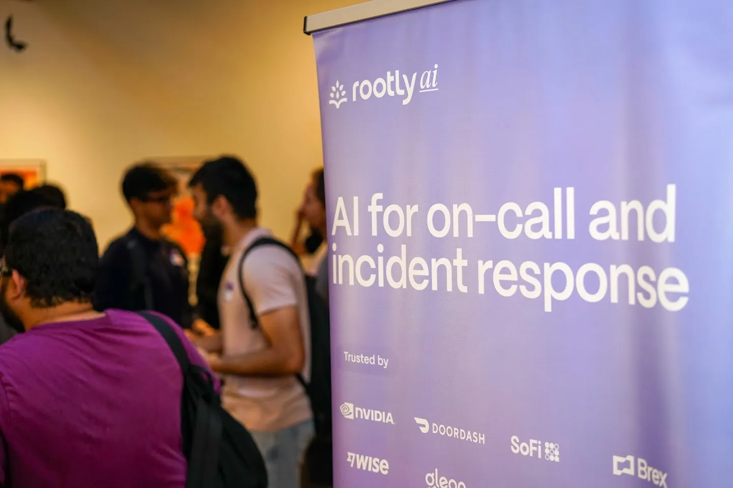 Rootly banner beside guests at AI Agents Builder Night