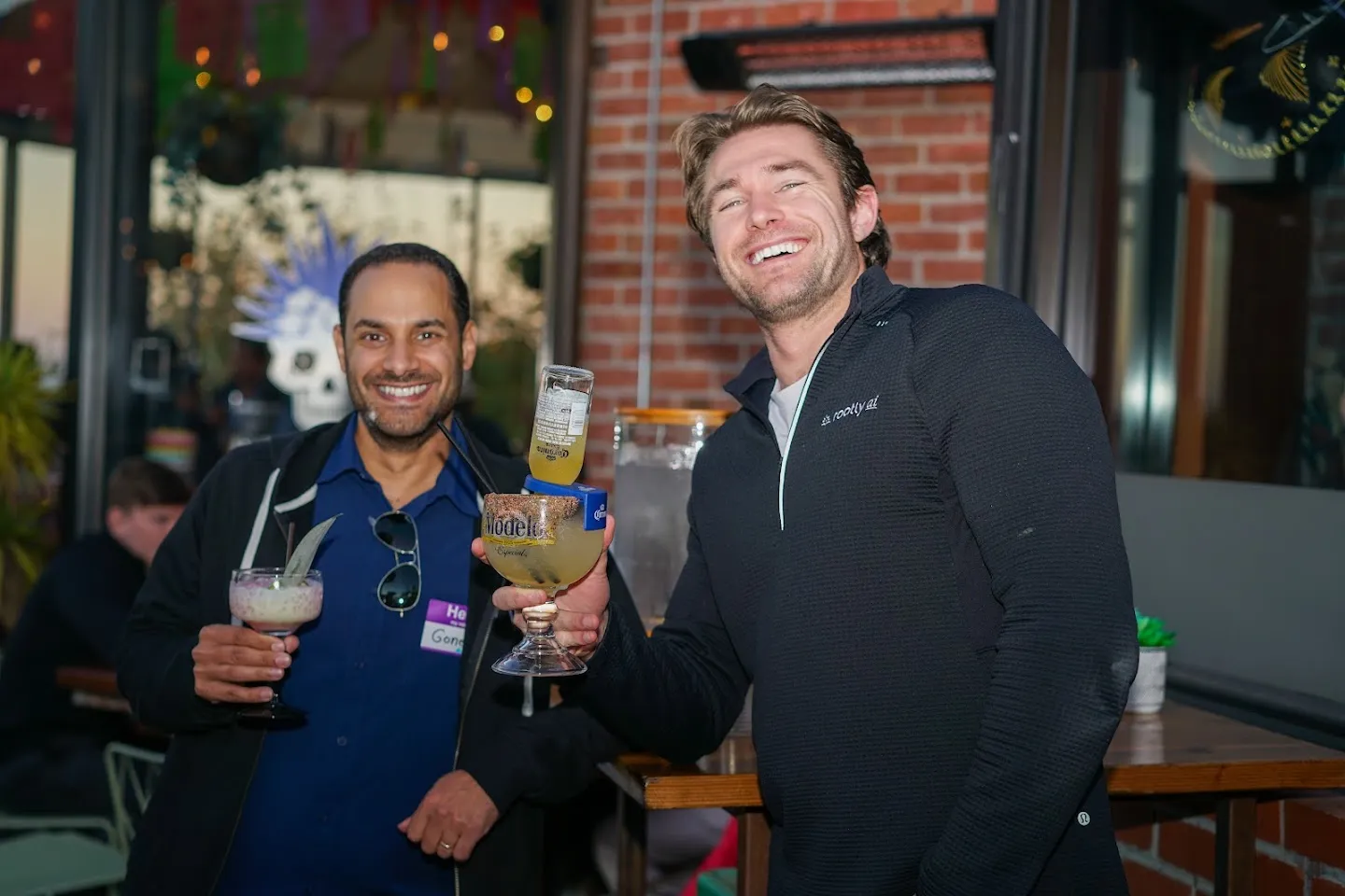 Two guests posing with drinks on the terrace