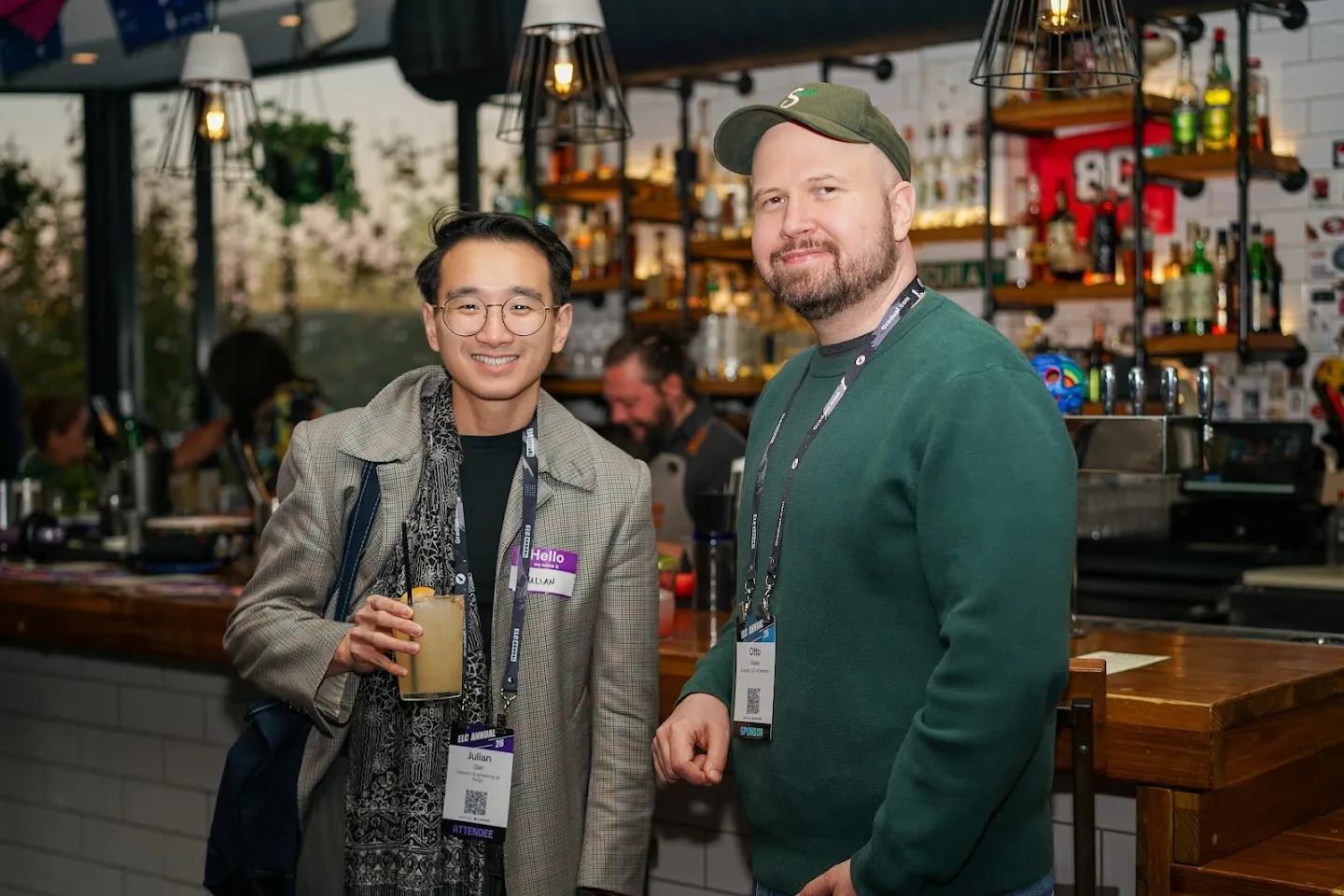Two guests posing beside the bar