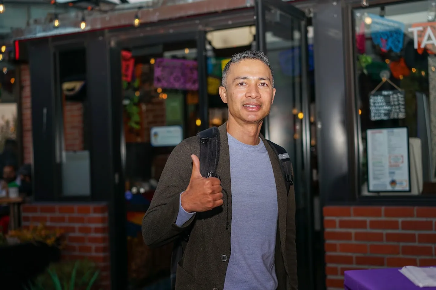 Guest giving a thumbs-up near the entrance