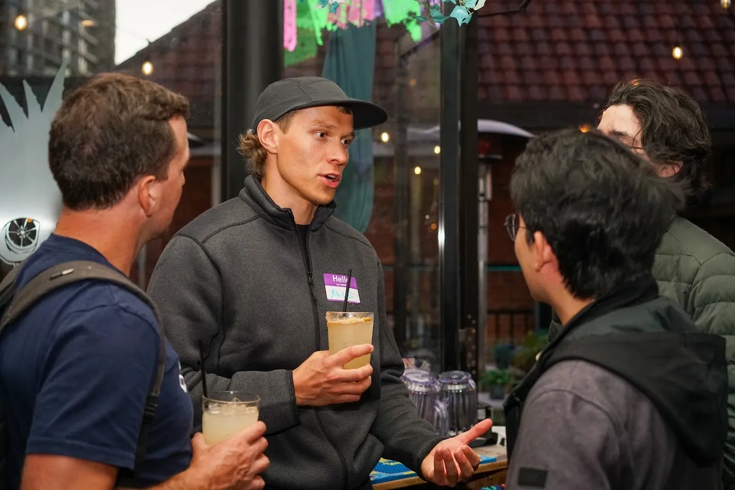 Guests chatting with drinks beside the terrace doors