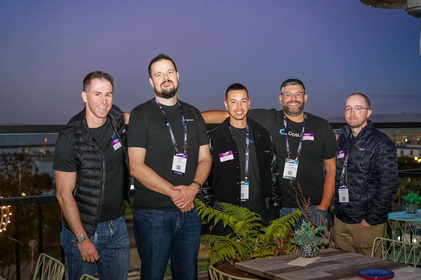Five attendees posing together on the terrace