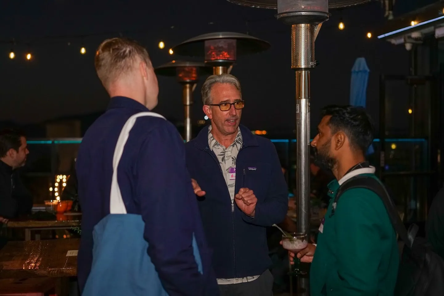 Guests in conversation on the terrace after dark