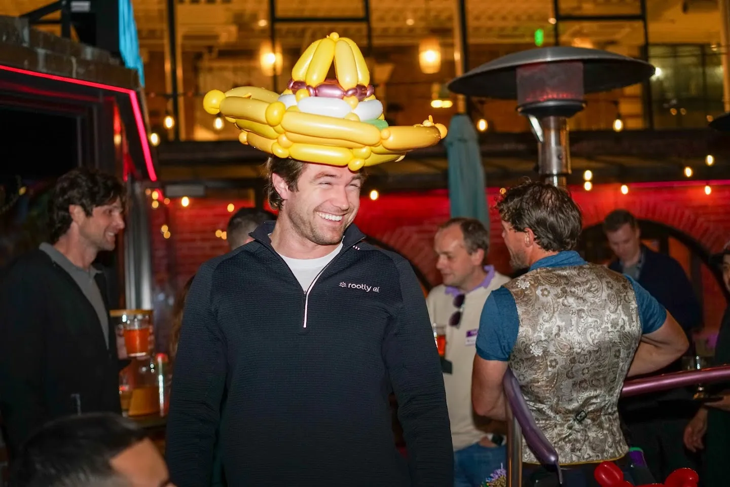 Guest wearing an elaborate gold balloon hat