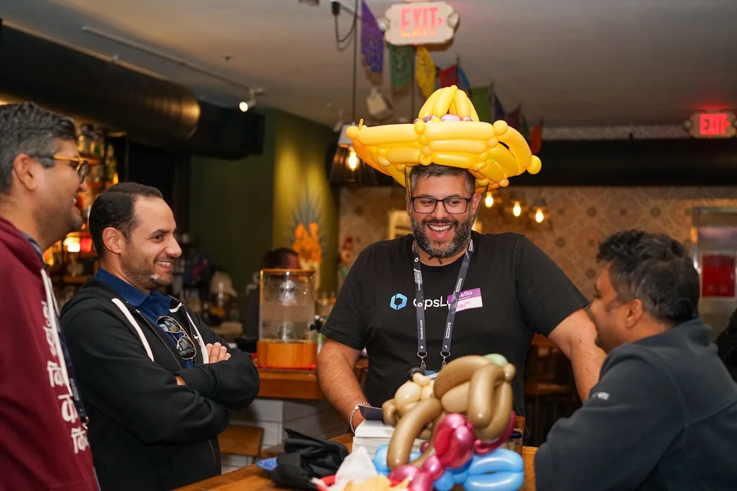 Guest laughing while wearing a yellow balloon hat
