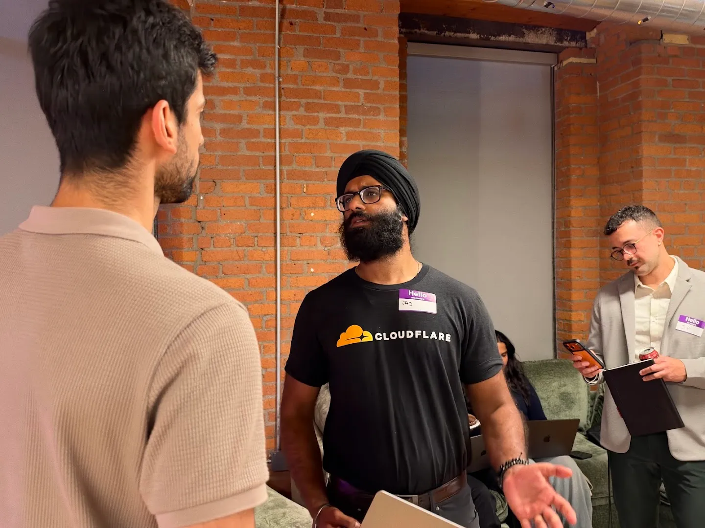 Builders discussing a project beside an open laptop