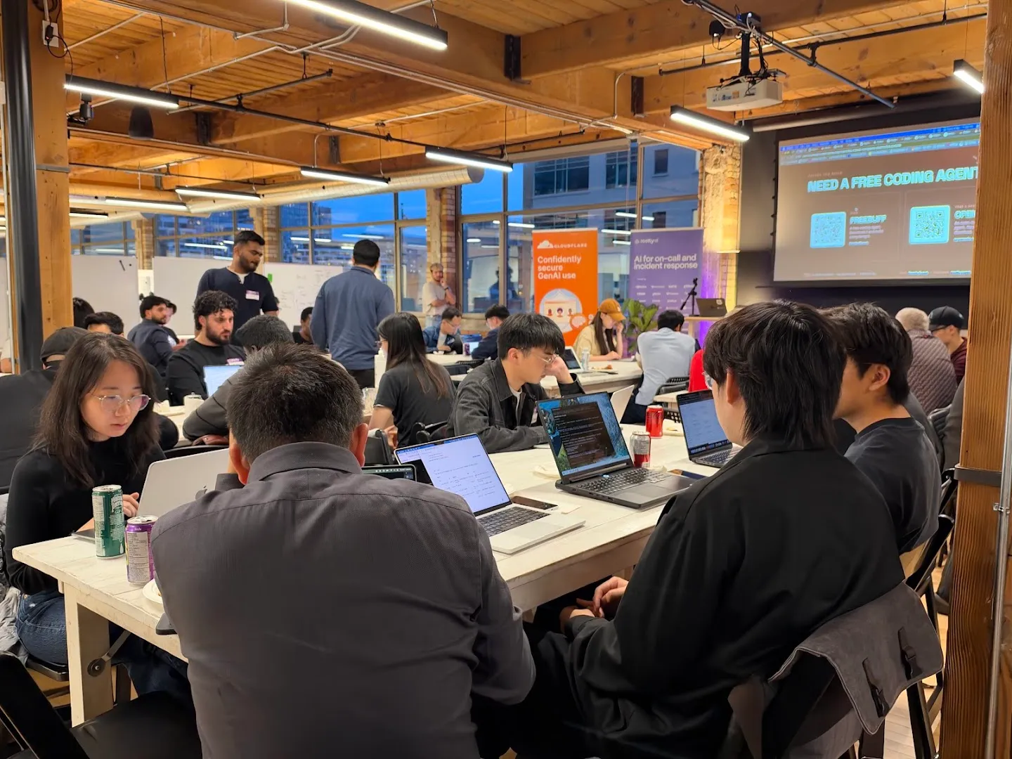 Attendees gathered around laptops for the AI agents workshop