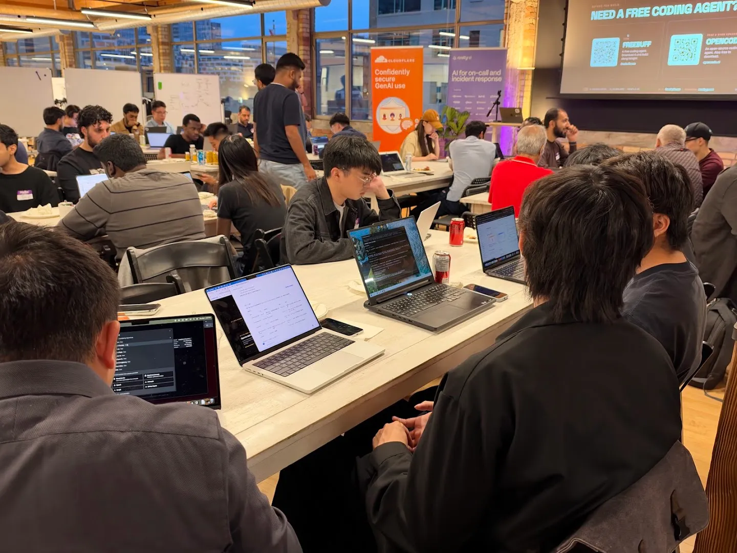 Attendees gathered around laptops for the AI agents workshop