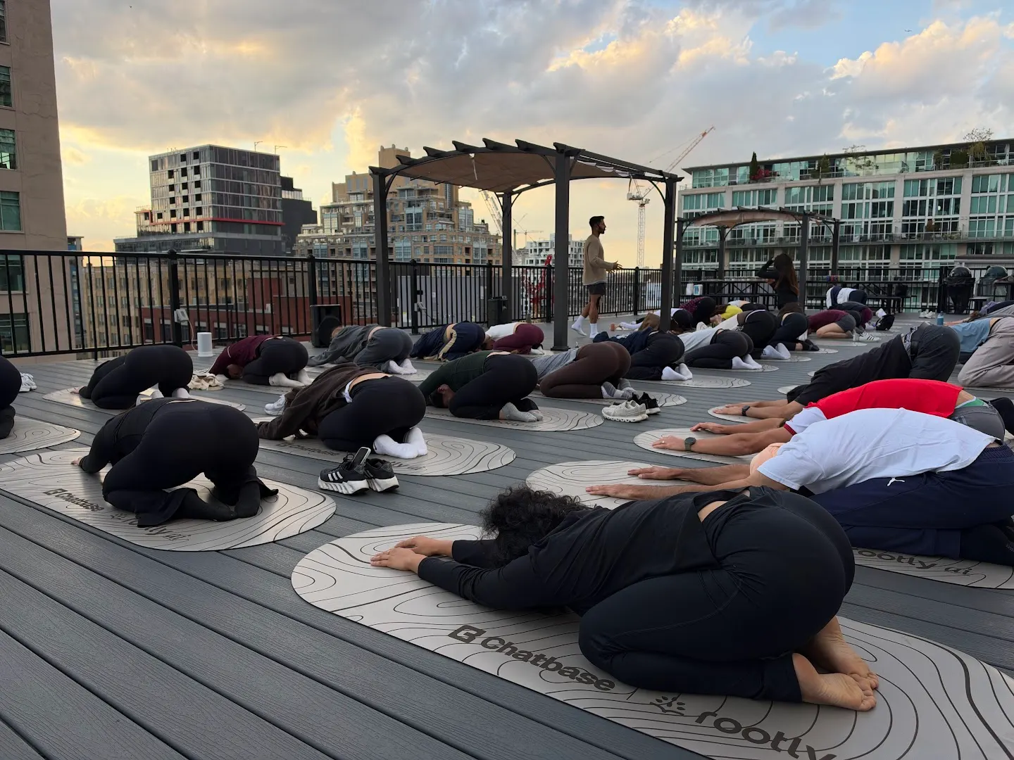 Participants practicing rooftop yoga at Rooftop yoga w Rootly x Chatbase (photo 1)