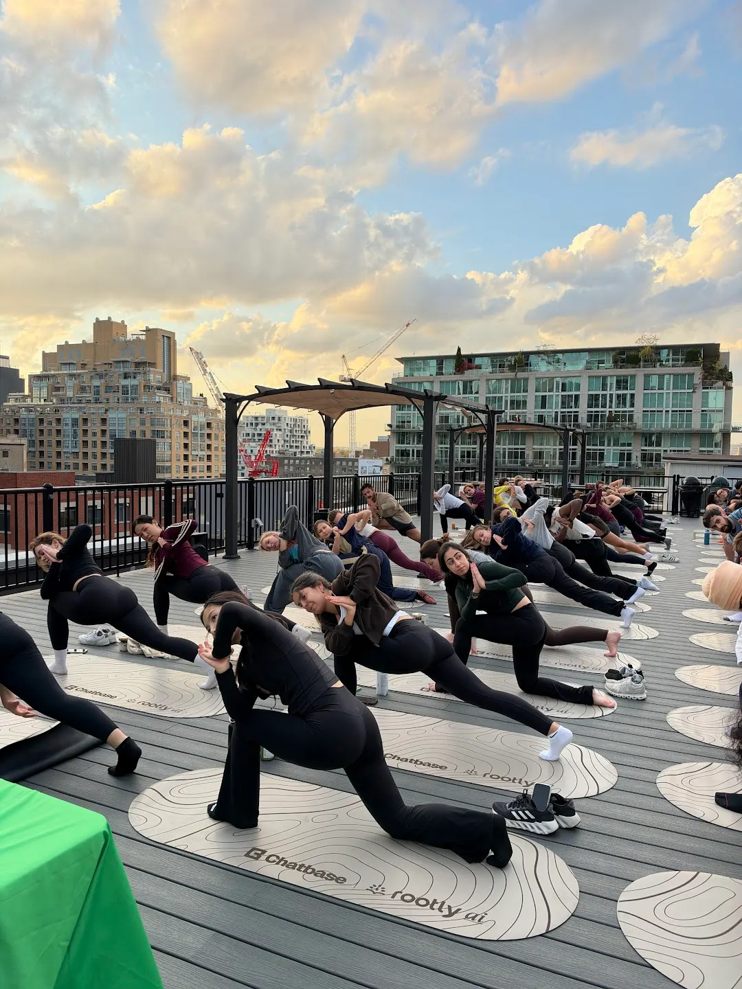 Participants practicing rooftop yoga at Rooftop yoga w Rootly x Chatbase (photo 3)