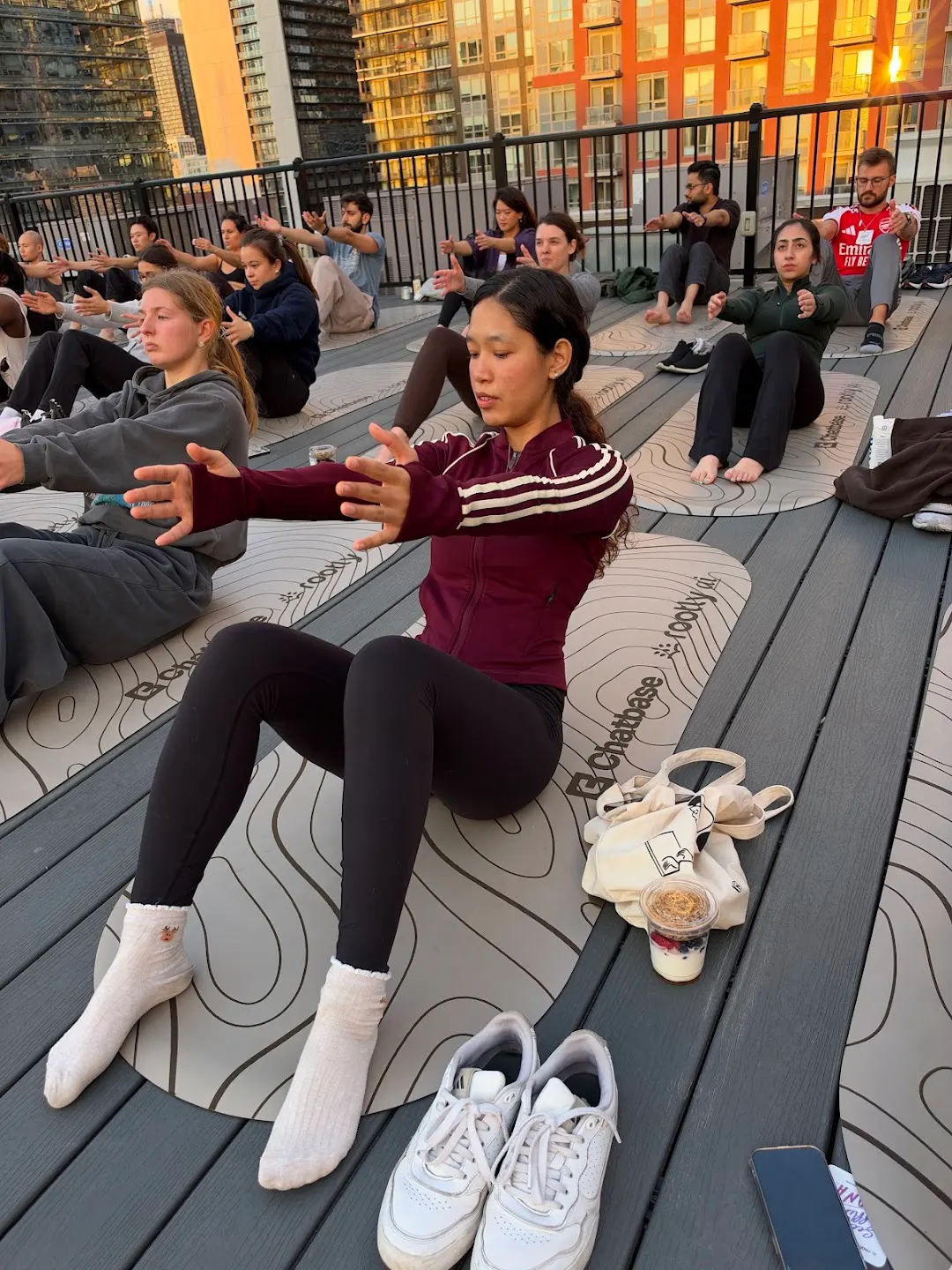 Participants practicing rooftop yoga at Rooftop yoga w Rootly x Chatbase (photo 6)