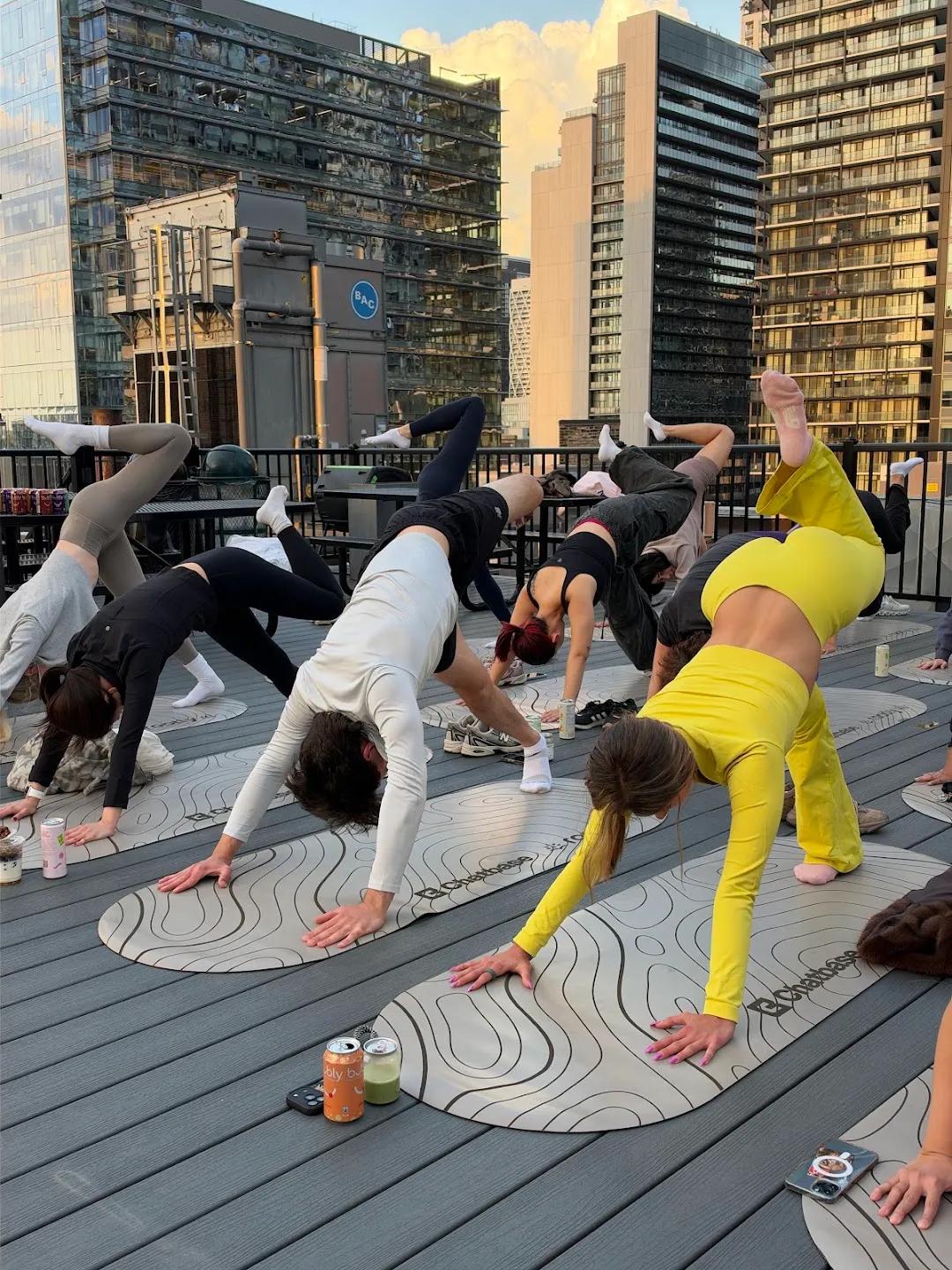 Participants stretching through standing yoga poses against the Toronto skyline