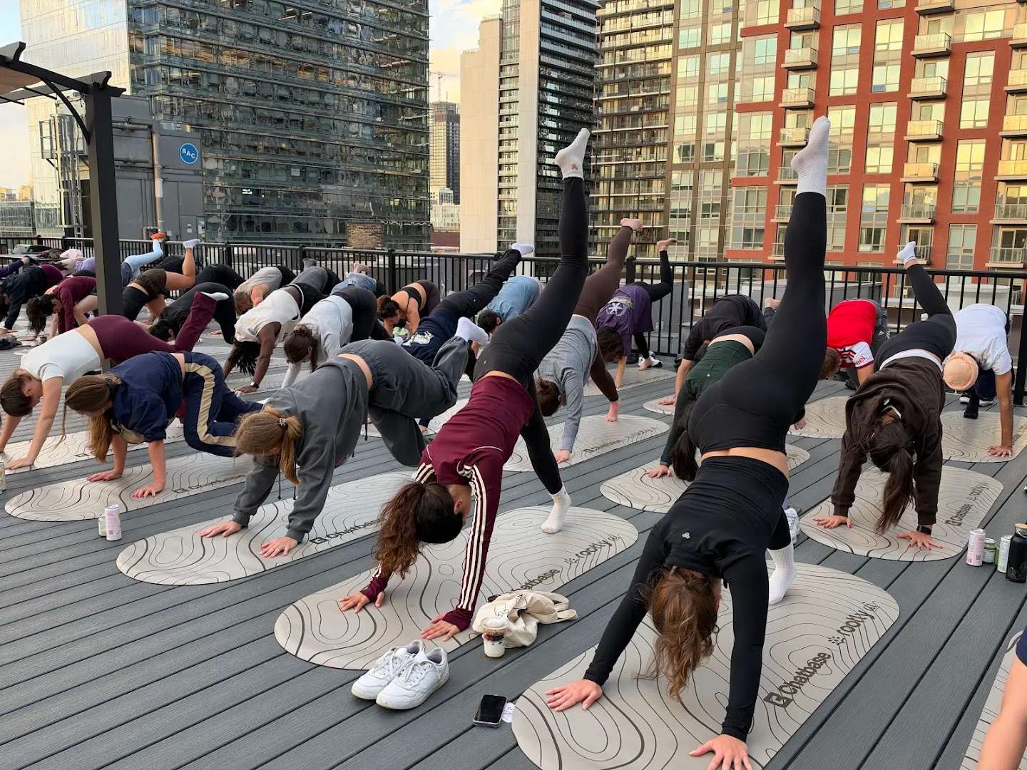 Participants stretching through standing yoga poses against the Toronto skyline