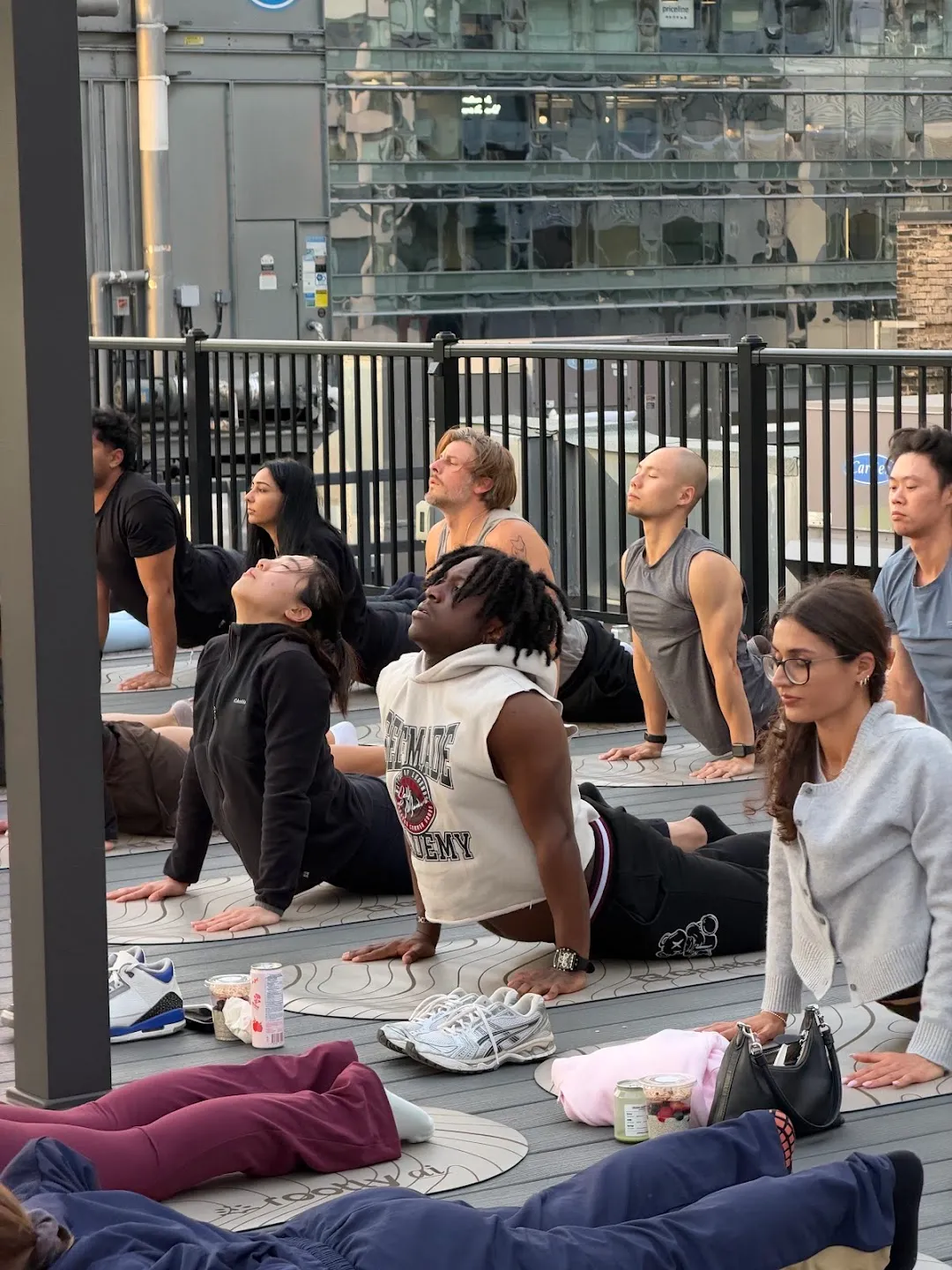 Participants seated on mats during rooftop yoga
