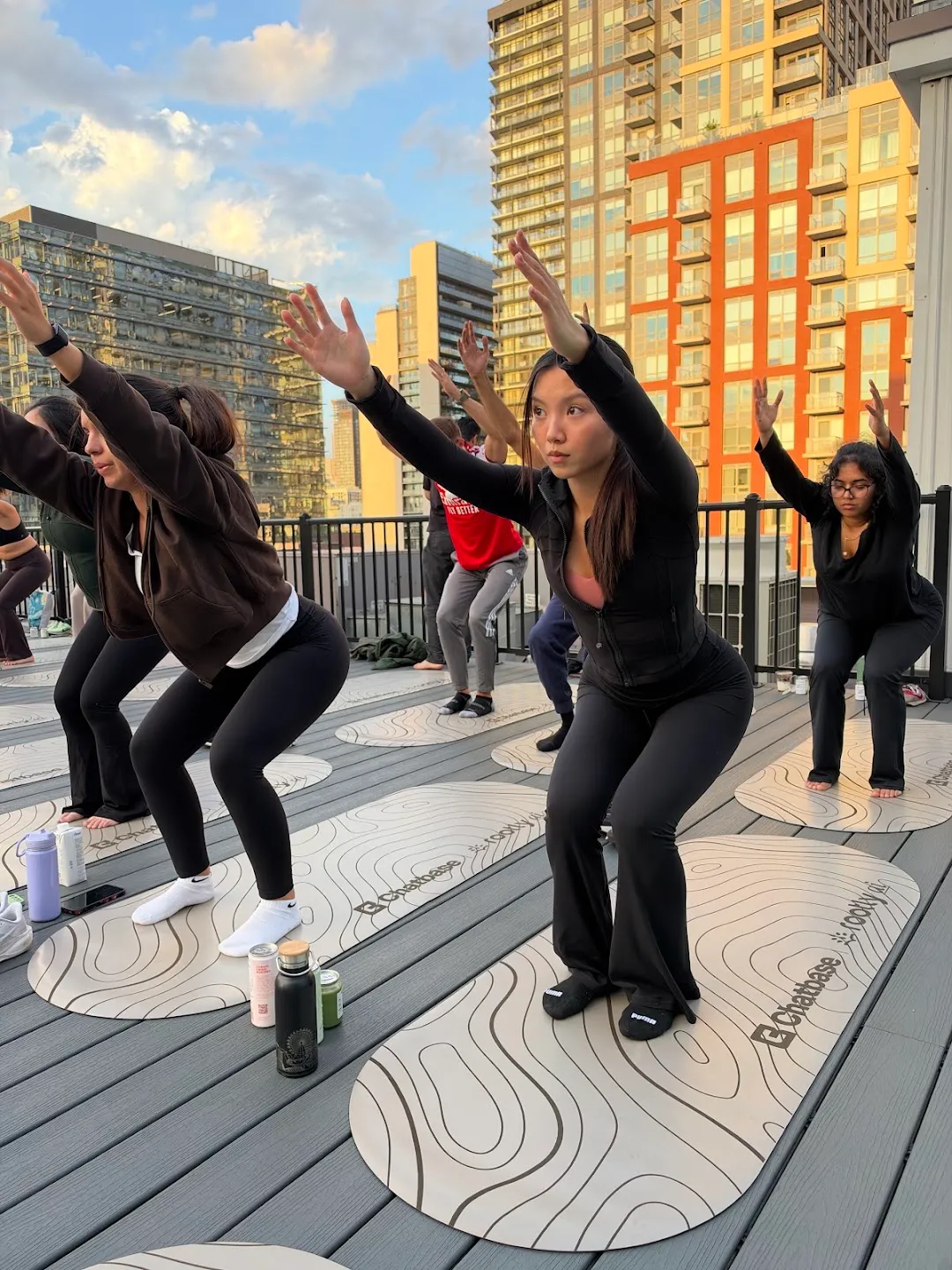 Participants stretching through standing yoga poses against the Toronto skyline