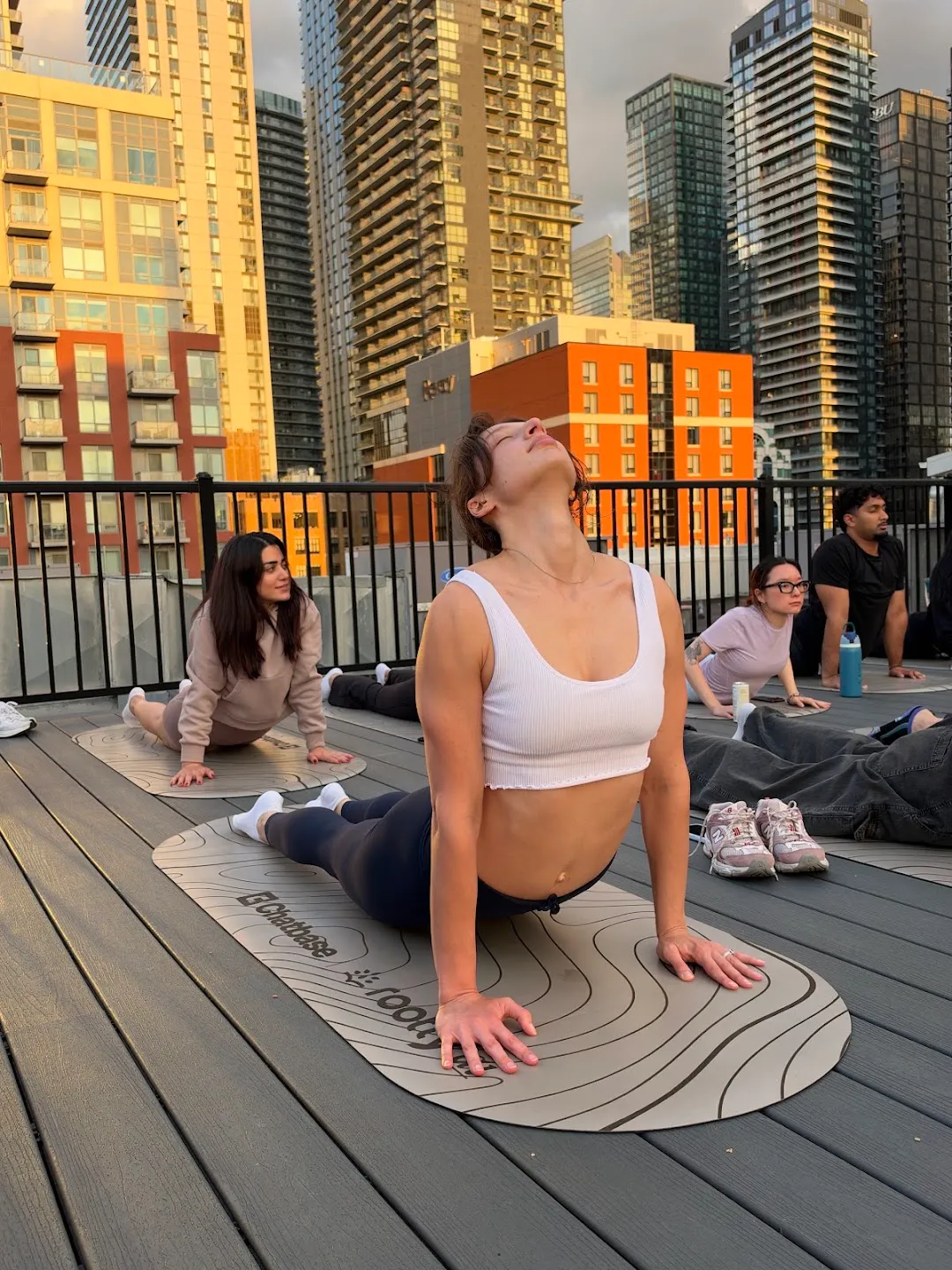 Participants moving through a floor sequence on yoga mats