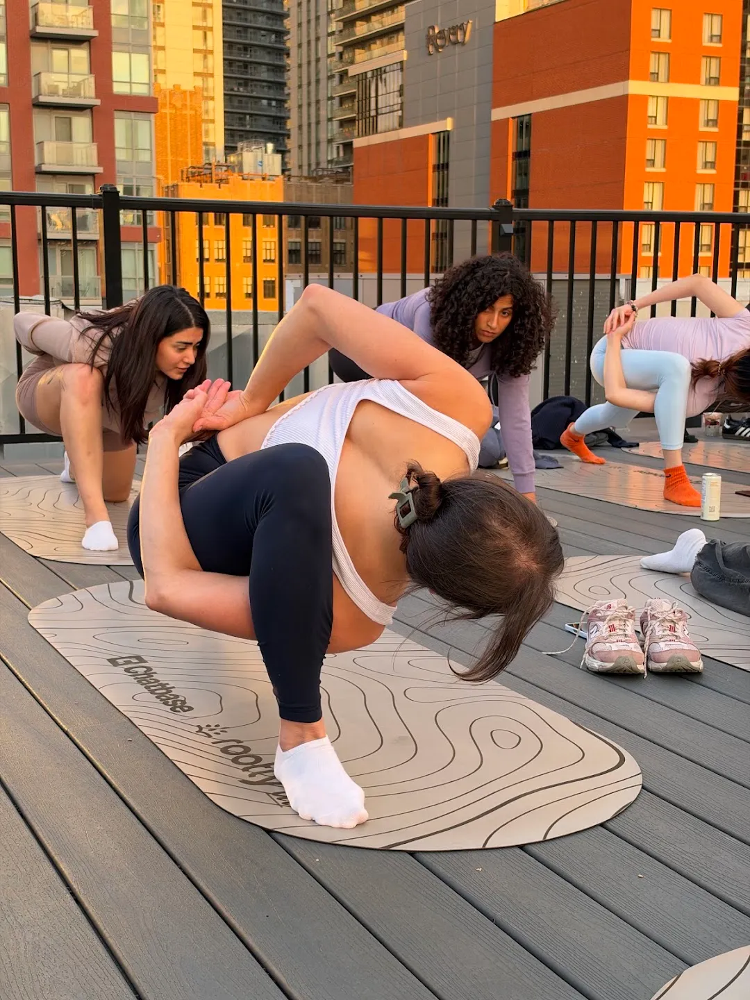 Participants moving through a floor sequence on yoga mats