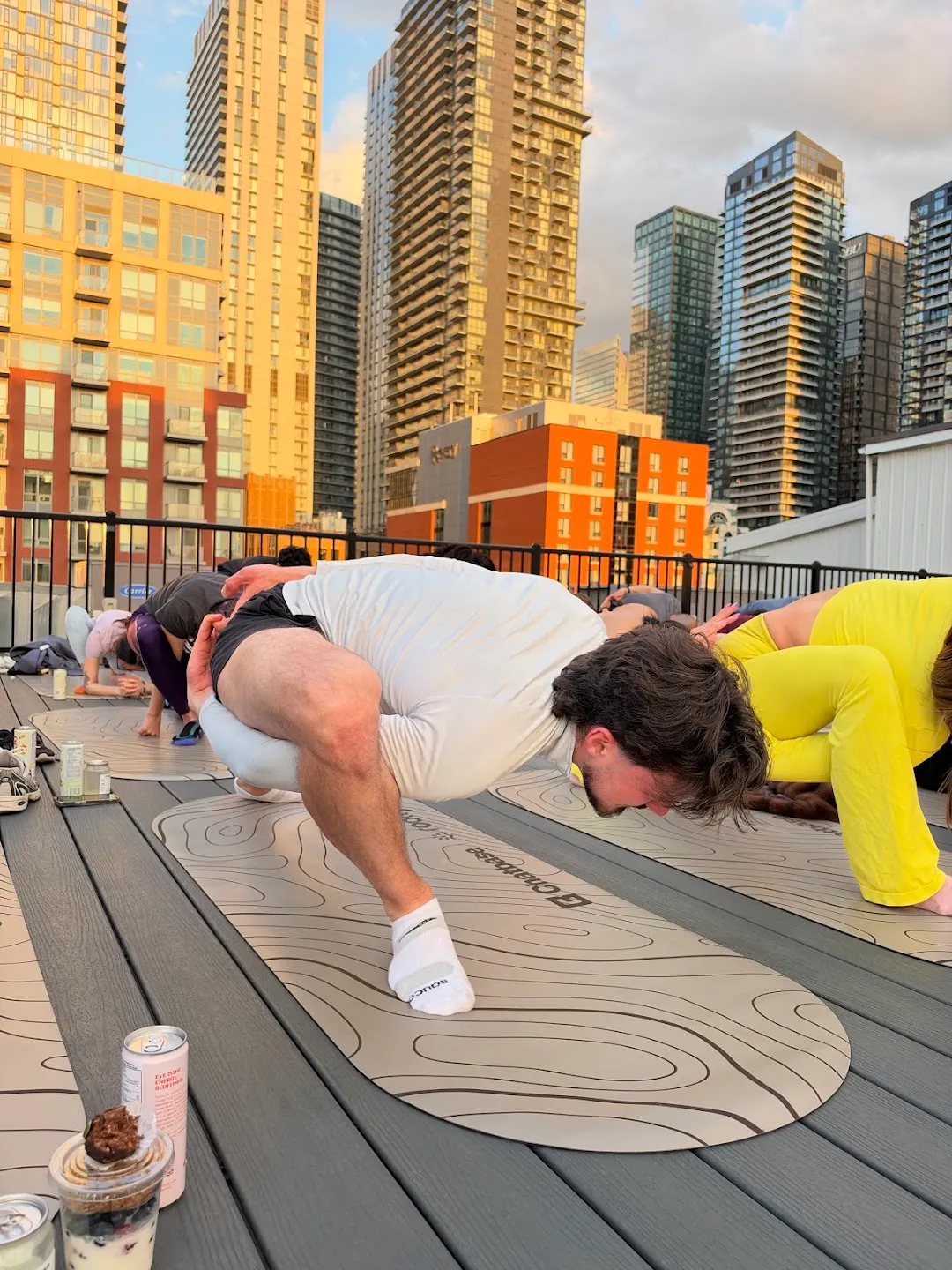 Participants moving through a floor sequence on yoga mats
