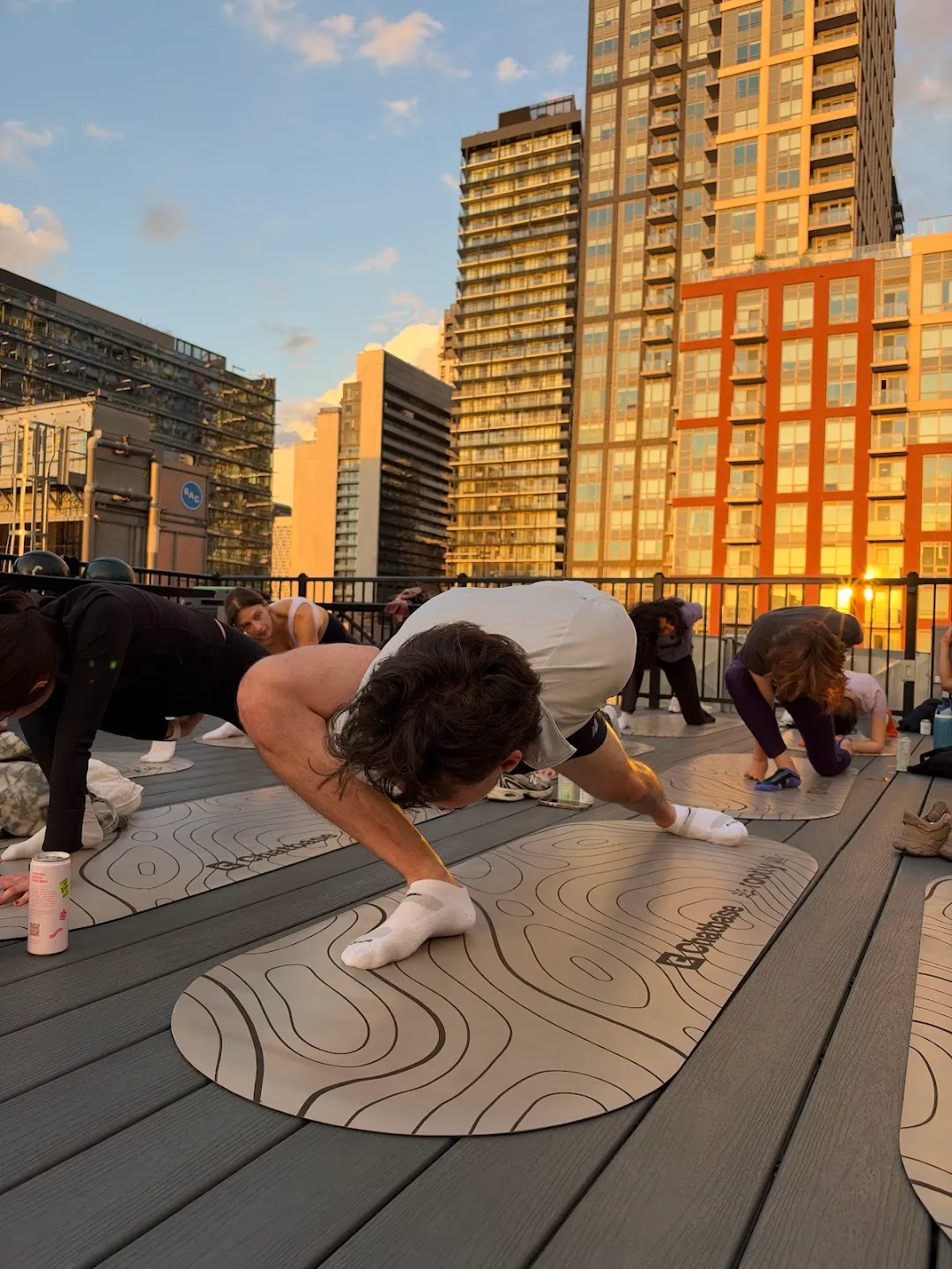 Participants moving through a floor sequence on yoga mats