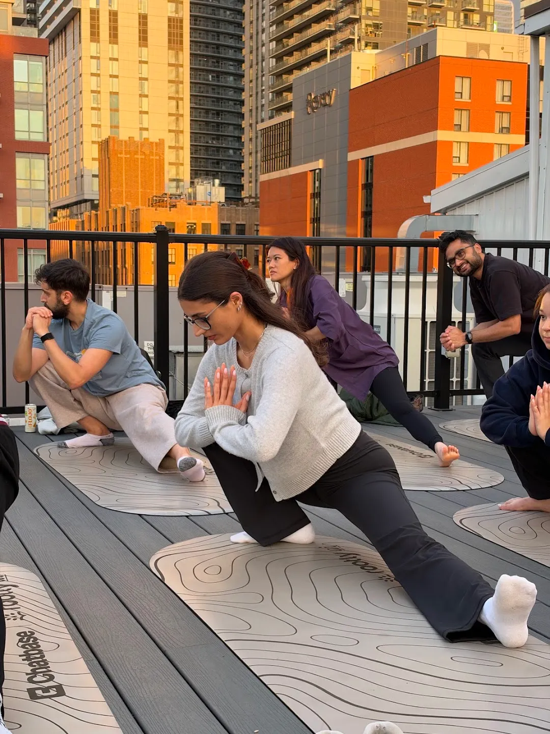 Participants seated on mats during rooftop yoga