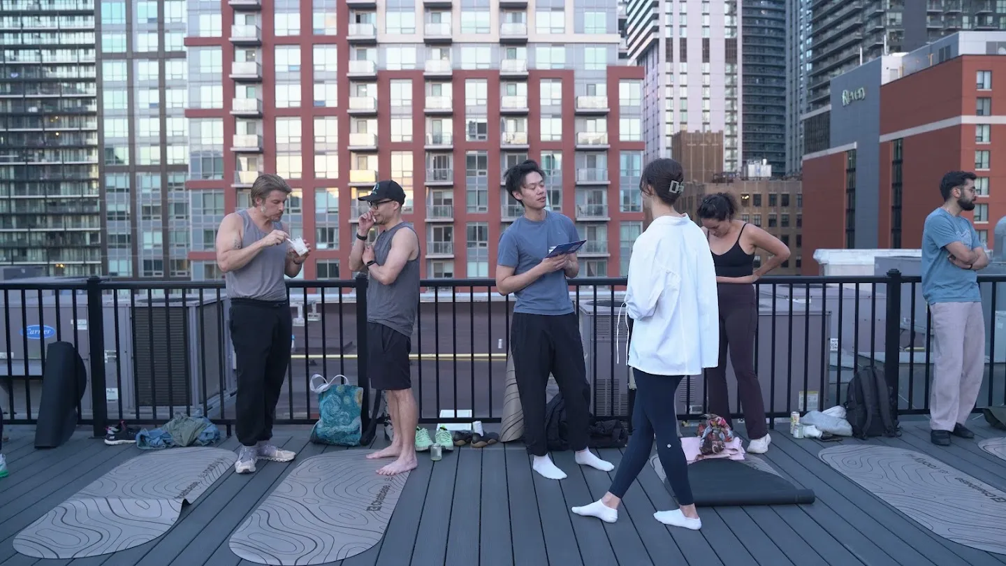 Guests talking on the rooftop after the yoga session