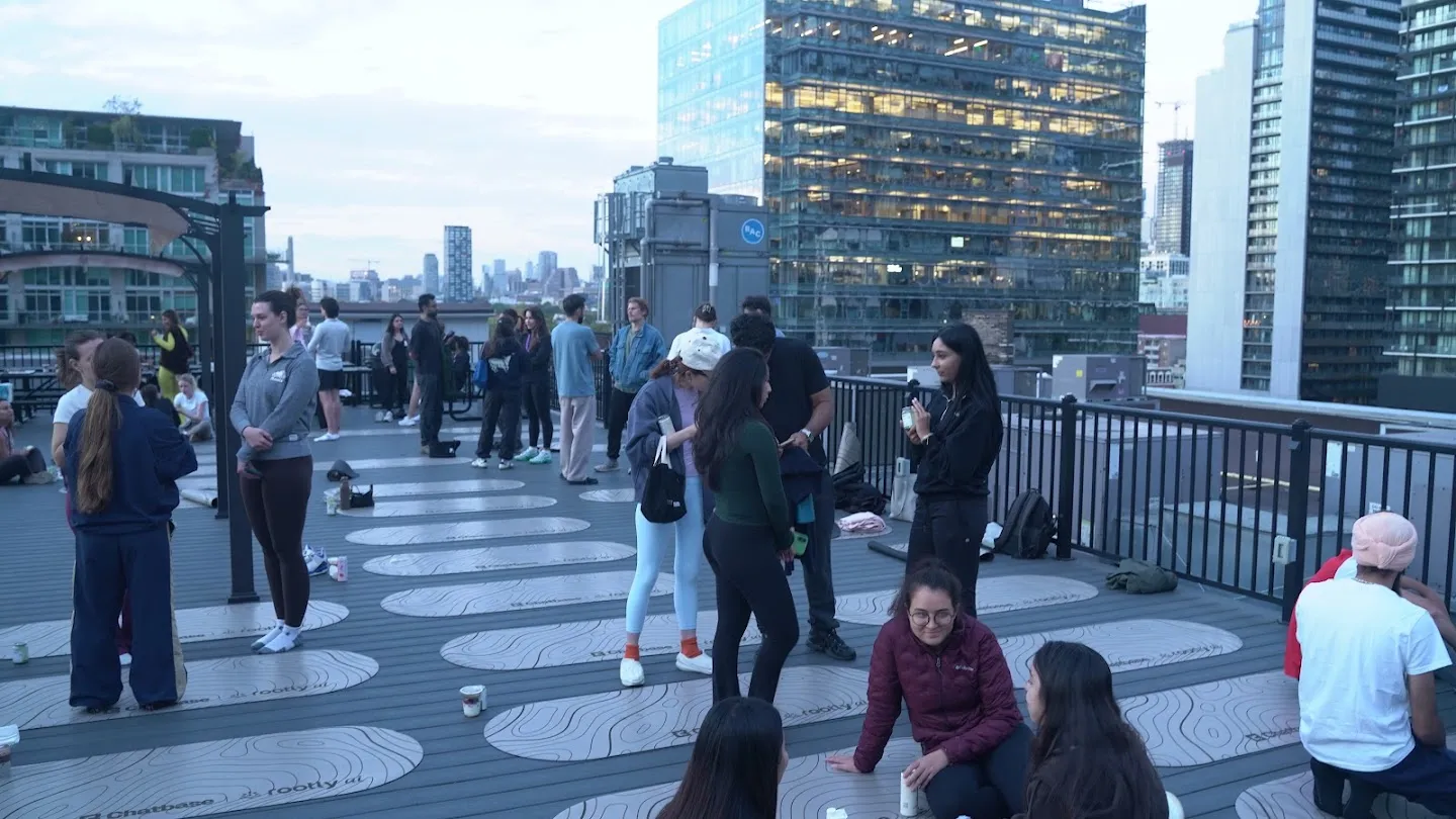 Guests talking on the rooftop after the yoga session
