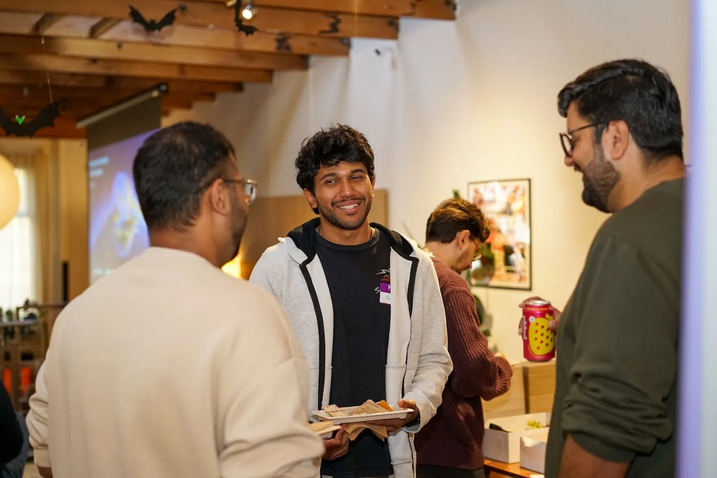 Guests chatting over food and drinks at the San Francisco meetup