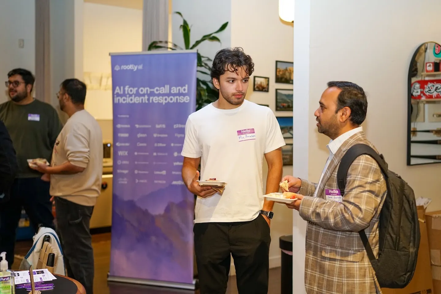 Guests talking beside the Rootly banner