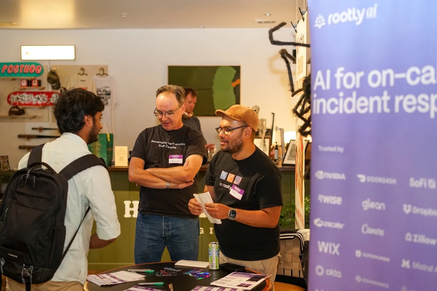 Guests talking beside the Rootly table and PostHog counter