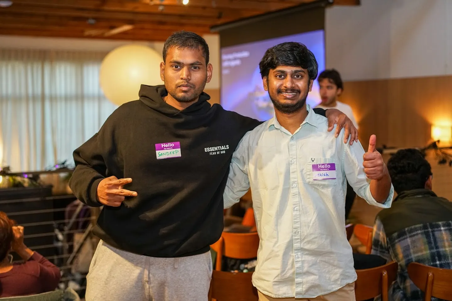 Two attendees posing together in the event lounge