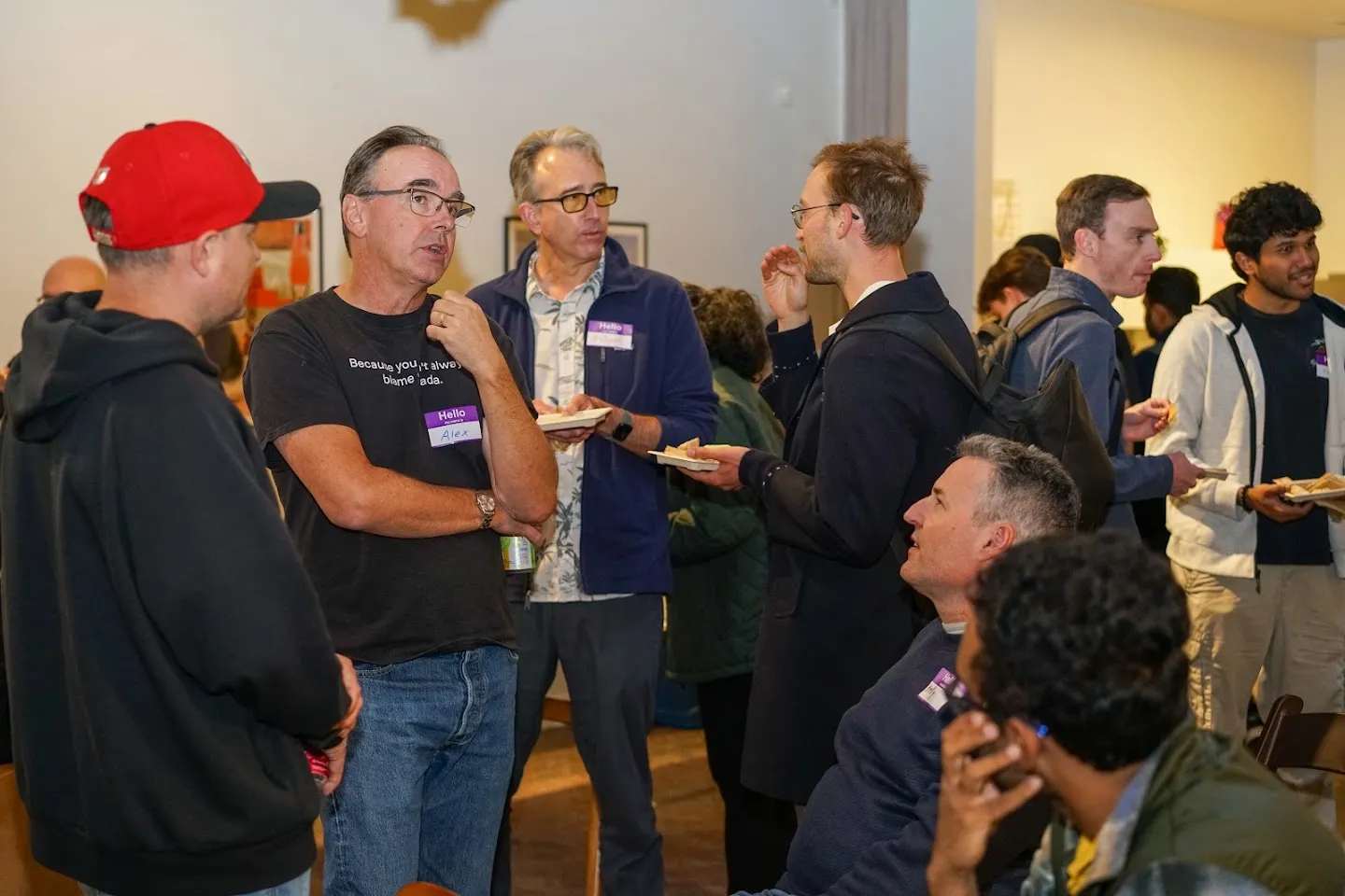 Attendees talking in a group before the panel