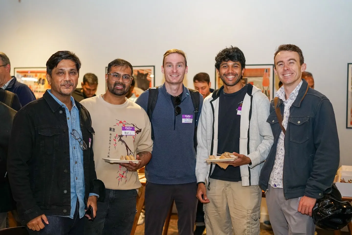 Five attendees posing together in the lounge