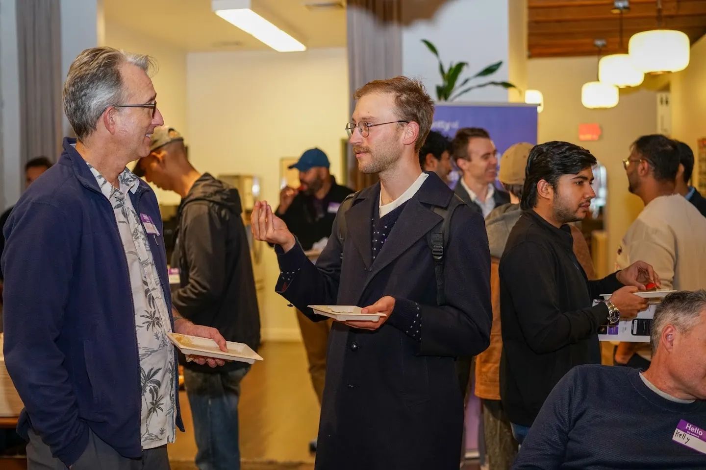 Guests in conversation beside the Rootly banner