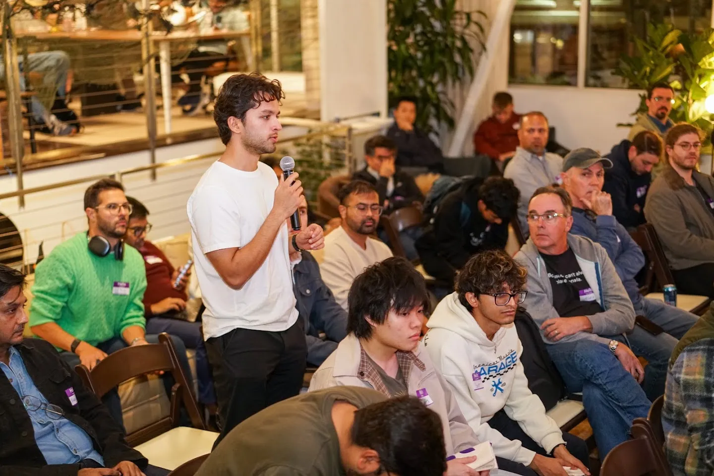 An audience member standing to ask the panel a question