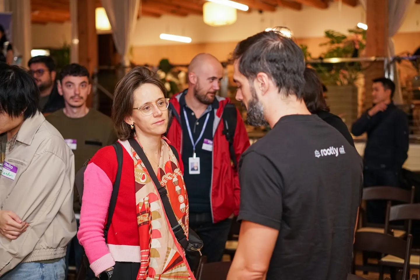 Guests talking with a Rootly team member after the panel