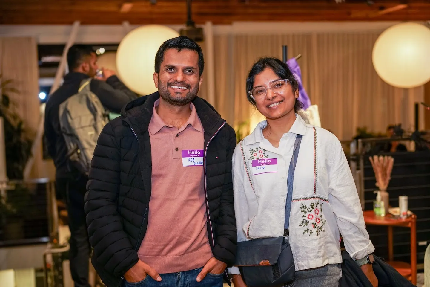 Two attendees posing together in the event space