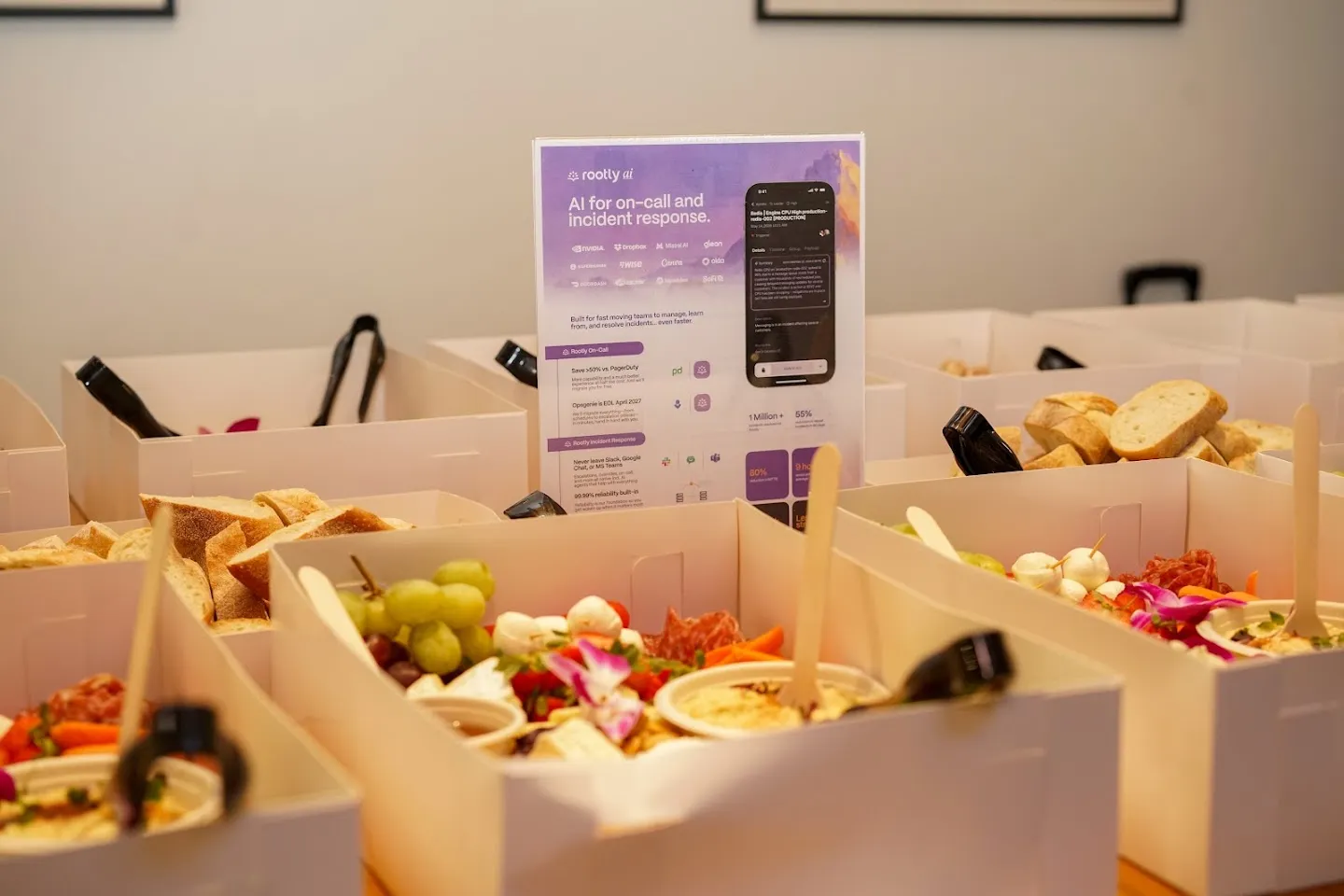 Food boxes and Rootly information on the refreshment table