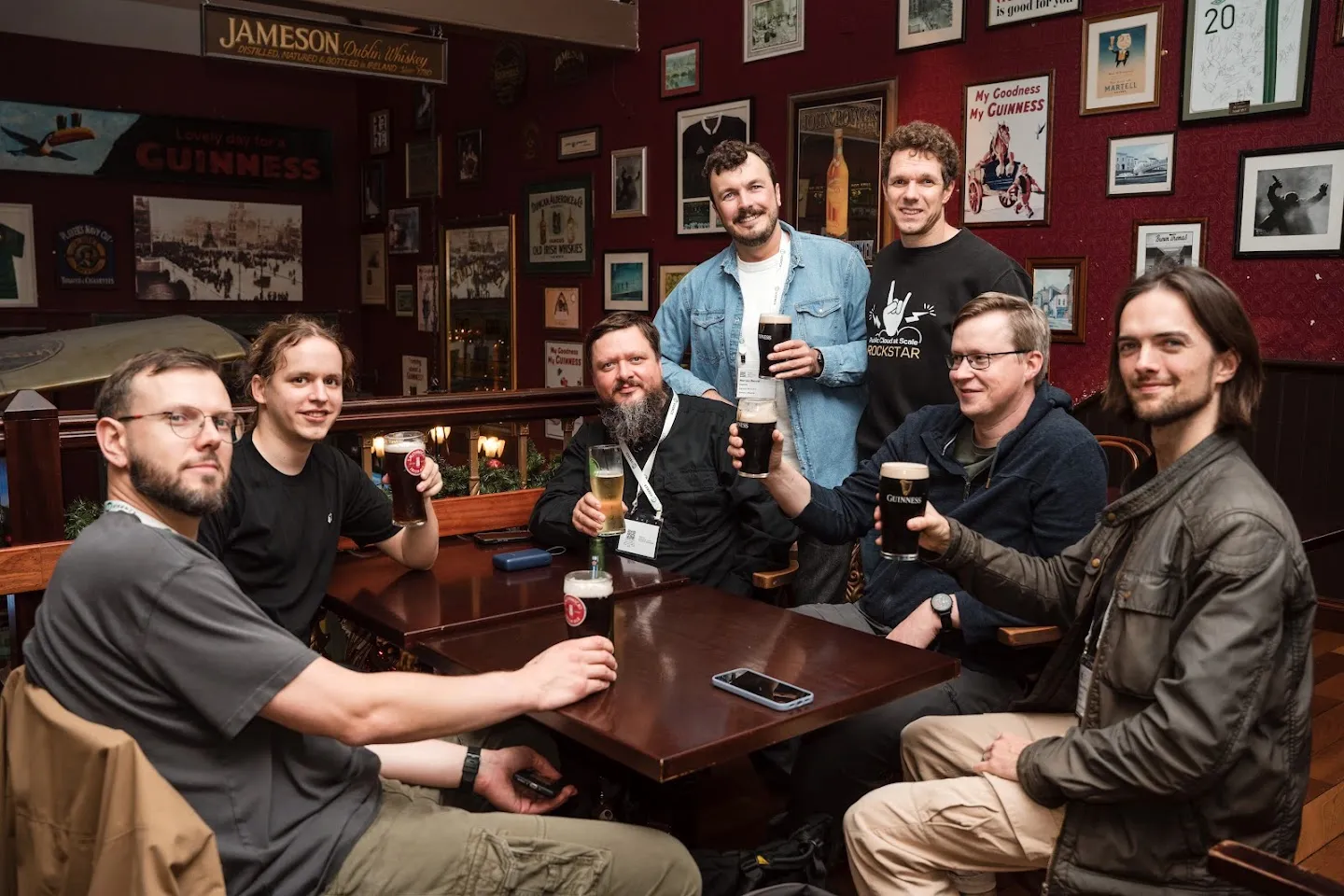 SREcon guests gathered around a pub table with their drinks