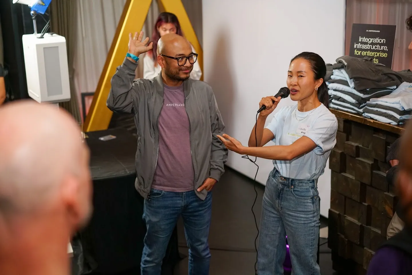Guests addressing the room with a microphone at Novela